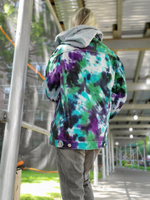 A back view showing the removable hood, which is not cotton, like the jacket itself. It is a poly sweatshirt fabric, and would not hold the dye. A nice contrast with the tie dye jacket