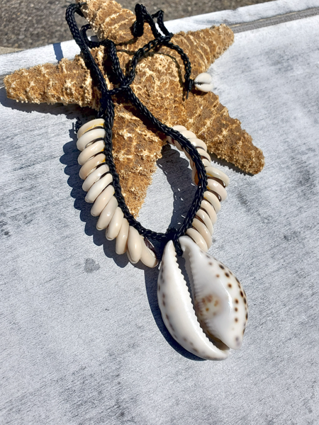 Starfish and shell necklace on a textured surface