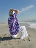 beach mood - a pretty shot on the sand. i'm also wearing a pair of white linen pants with this purple tie dye tunic