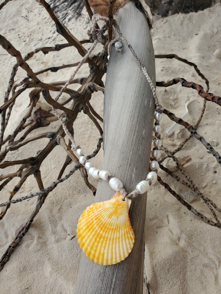 Large yellow shell pendant on a hemp cord, knotted, with fresh water pearls, long and adjustable ties. Can be worn short or long
