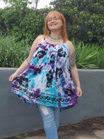 Zoey, who is a size Xl is modeling this one size mini dress or tunic. This style has adjustable straps, a parachute shape,  the very lightweight woven rayon fabric  that I got in white, also has printed black flowers on. I hand dyed this piece in aqua and purples shades.