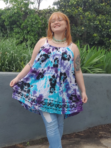 Zoey, who is a size Xl is modeling this one size mini dress or tunic. This style has adjustable straps, a parachute shape,  the very lightweight woven rayon fabric  that I got in white, also has printed black flowers on. I hand dyed this piece in aqua and purples shades.