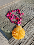 yellwo shell pendant with a white pearl accent, on a crocheted pink-red gemstone beads chain