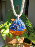 flat lapis lazuli beads stitched on a linen crocheted base, then sewn onto the orange shell