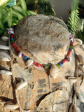 Colorful beaded necklace with shells on a textured form