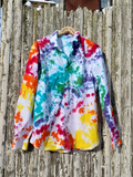 Colorful tie-dye shirt hanging on a wooden fence