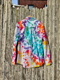 Colorful tie-dye shirt hanging on a wooden fence