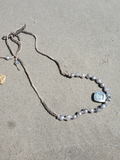 showing the back of the pendant with the silver setting
