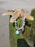 silver pearls necklace at the beach