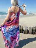 Woman in a tie-dye dress on a beach
