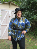 My curvy model Ana is wearing a size 3xl cardigan that has a short back, open drape front. She is wearing a black belt, top and leggings under the tie dye cardigan. The colors are olive & navy.