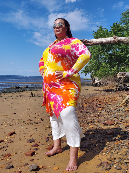 Ana, a size 2/3X beauty is standing at the beach with hands on her hips; wearing my tie dye basic midi cardigan with pockets.