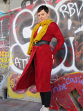 Style photo with the belt around the cardigan, and the added mustard color long gauze scarf. hands on her hips, front slightly blowing in the wind.