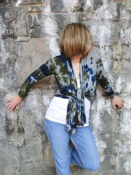 My friend Jodi is the model here; wearing a short drape open front cardigan hand dyed in olive navy colors. The original color was an heather grey color,which is still visible between the dyed areas. Here we just tied the fronts across her front. 