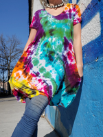 Short sleeve babydoll dress or tunic, pockets, just above my knees, V-neck. Tie dyed in bright rainbow colors. I'm modeling a small dress with blue leggings