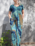 I have a short sleeve floor length slightly A-line dress with pockets and V-neck on. The dress came in a sage color, I had dyed it in navy-khaki-denim colors. Frontal view.