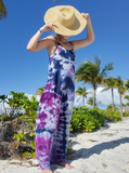 Maxi dress with adjustable straps and pockets, the powder blue dress is dyed over in navy and purple shades. Floor length. I'm covering my face with my straw hat.