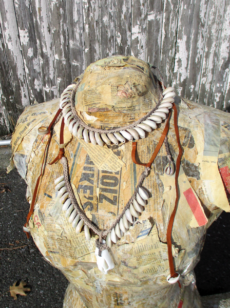 there are 2 different shell necklaces displayed on a paper Mache form - sold separately!